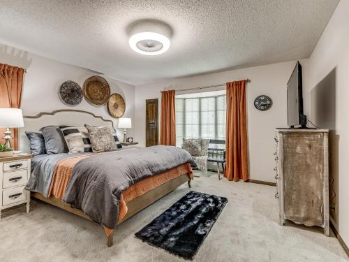 a bedroom with a bed and a television in it at Farmhouse on 7 ac by Norman in Lillard Park