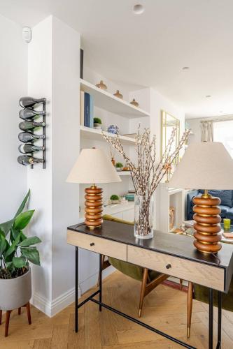 two lamps on a table in a room at Delightful Notting Hill 2 bed House with garden in London