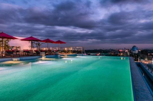 a swimming pool on the roof of a building at night at Luxury Skynest with Gym and Pool in Westlands in Nairobi