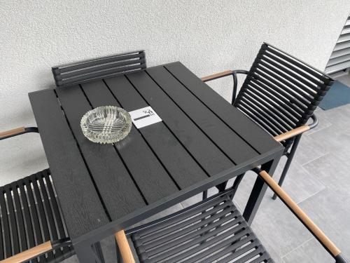 a black table and chairs with a napkin on it at Modern Living in Budapest 2 in Budapest