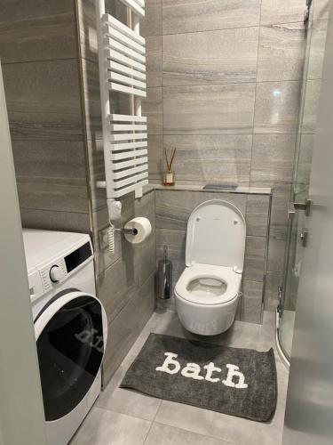 a small bathroom with a toilet and a rug at Modern Living in Budapest 2 in Budapest