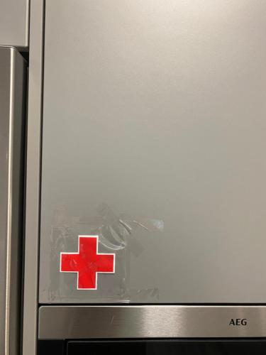 a silver refrigerator with a red cross on the door at Modern Living in Budapest 2 in Budapest