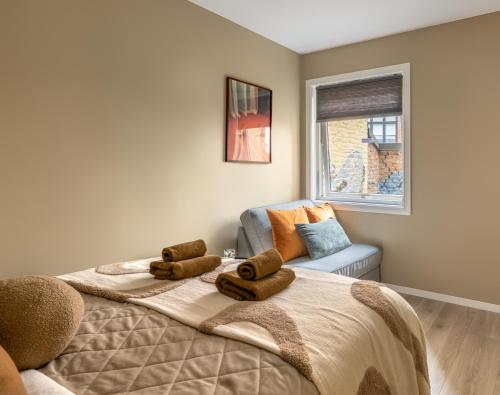 a bedroom with a bed with two towels on it at Beautiful apartment in the heart of Oslo! in Oslo
