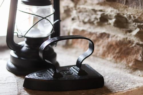 a black iron object sitting on a table next to a lamp at Ferienhof Mayischhof in Lauperath