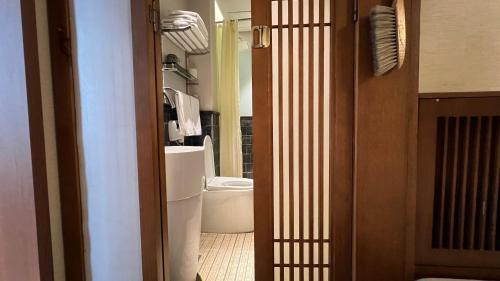 a bathroom with a toilet and a sink in a room at 嵩山居-丽晶精品民宿 in Dengfeng
