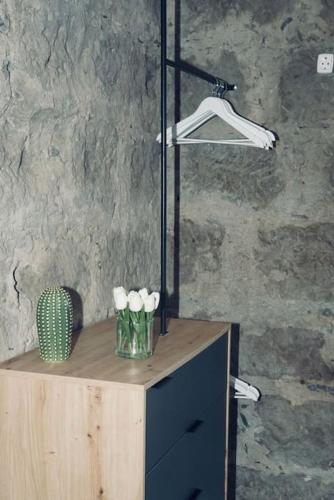 a table with a vase with white flowers on it at El Alpendre in Moya