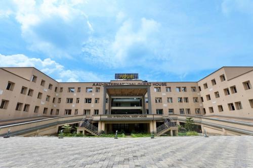 a large building with stairs leading up to it at Rohika AAU-IGH in Guwahati