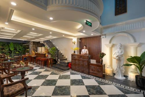 a person standing in a room with a lobby at Tam Coc Mountain Sunset and Garden Hotel in Ninh Binh