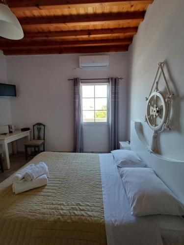 a bedroom with a large bed with a mirror on the wall at Manos Rooms in Mýkonos City