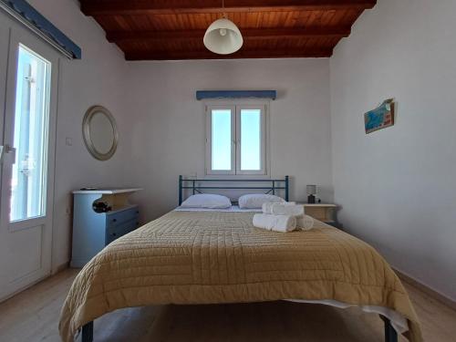 a bedroom with a bed with two towels on it at Manos Rooms in Mýkonos City