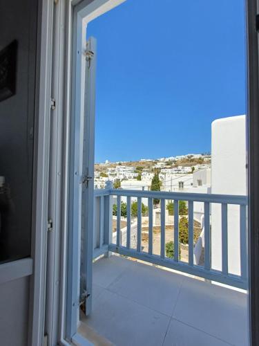 a balcony with a view of the ocean at Manos Rooms in Mýkonos City