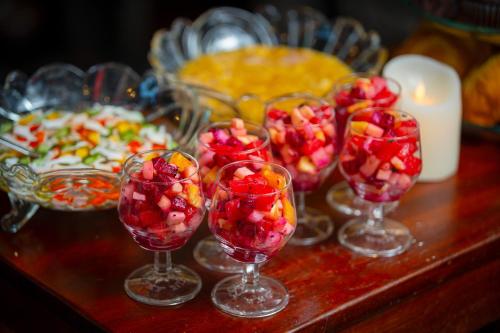 a group of wine glasses filled with fruit on a table at Tam Coc Mountain Sunset and Garden Hotel in Ninh Binh