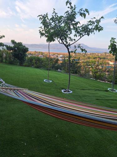 a hammock in a park with a view of a city at Villa View in Oropós