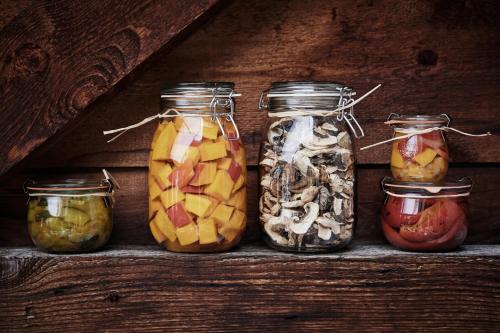 a row of jars filled with different types of food at Nostalgie Bed & Breakfast Chrämerhus in Curaglia