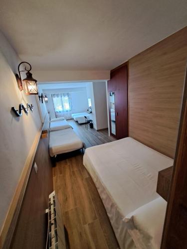 a bedroom with two beds and a couch at Hotel Avanti in Pas de la Casa
