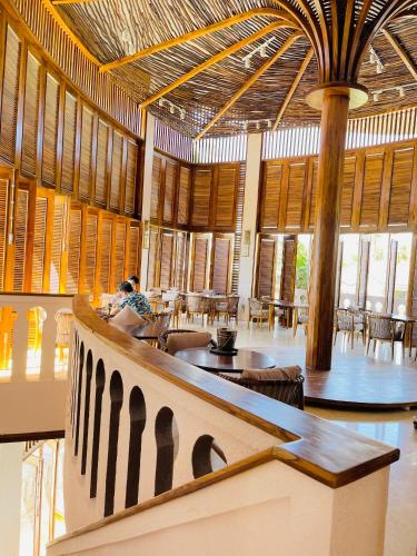 a large room with tables and chairs in a building at Le' VIVA Resort Mui Ne in Mui Ne