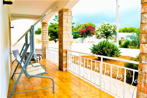 a balcony with a bench and a view at Casadamarepg Gallipoli in Pizzo