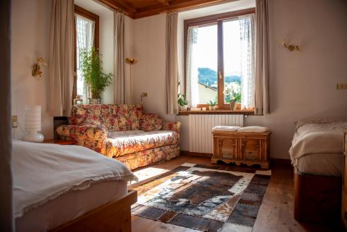 a living room with a couch and a window at Masito Apartments The Hub in Cortina dʼAmpezzo