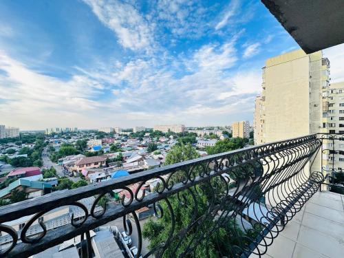 a balcony with a view of a city at Гавань Счастья in Almaty