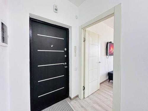 a black door in a room with a hallway at Гавань Счастья in Almaty