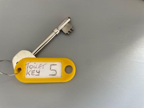 a yellow object with the words toilet key on a wall at Entire 8 Ensuite Bedroom Coastal Holiday Home Townhouse, Free Parking, Fully Equipped Kitchen, Dining Room & Lounge, Perfect for Family Gatherings, Long Term Contractor, Relocation, etc Stays, 20 mins to Sunderland & Newcastle, See our Site for Assurance in South Shields