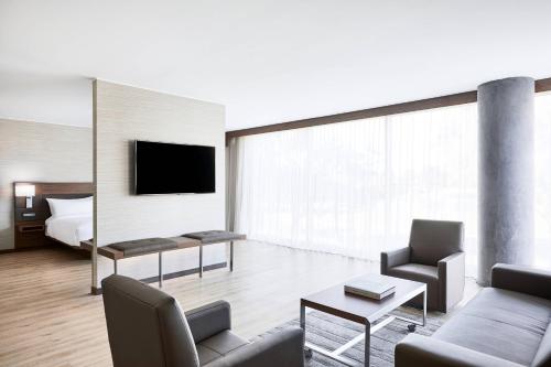 a living room with a couch and a bed at AC Hotel Phoenix Biltmore in Phoenix