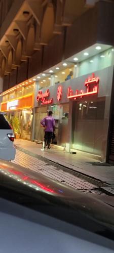 a man walking down a sidewalk in front of a store at MAMA DELiGHT HOME in Abu Dhabi
