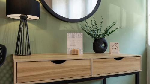 a wooden dresser with a lamp and a mirror at Heraklion Crete Monis Prevelis 74 3BRS 2BTHS Fast WiFi in Bendevís