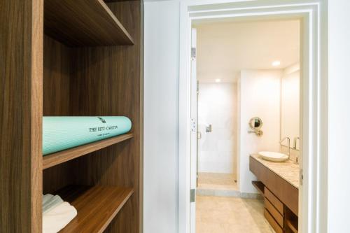 a bathroom with a surfboard on a shelf at The Ritz-Carlton Residences, Turks & Caicos in Providenciales