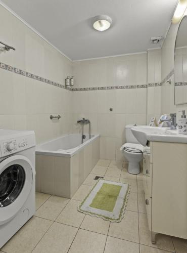 a bathroom with a washing machine and a sink at Heraklion Crete Monis Prevelis 74 3BRS 2BTHS Fast WiFi in Bendevís