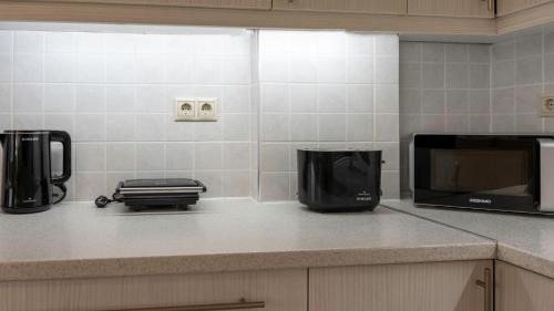 a kitchen counter with a microwave and a coffee maker at Heraklion Crete Monis Prevelis 74 3BRS 2BTHS Fast WiFi in Bendevís