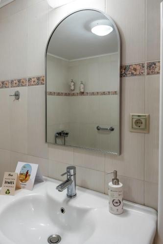 a bathroom with a sink and a mirror at Heraklion Crete Monis Prevelis 74 3BRS 2BTHS Fast WiFi in Bendevís