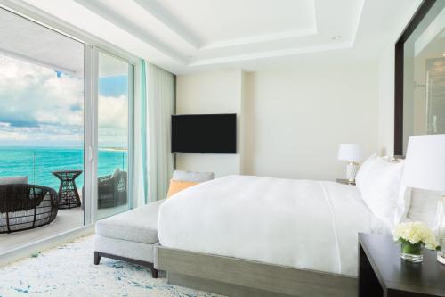a bedroom with a bed and a view of the ocean at The Ritz-Carlton Residences, Turks & Caicos in Providenciales