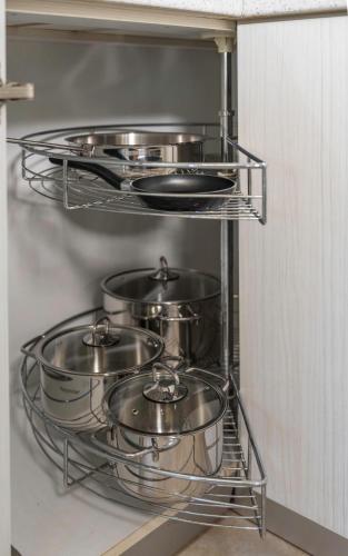 a group of pots and pans on a shelf in a kitchen at Heraklion Crete Monis Prevelis 74 3BRS 2BTHS Fast WiFi in Bendevís