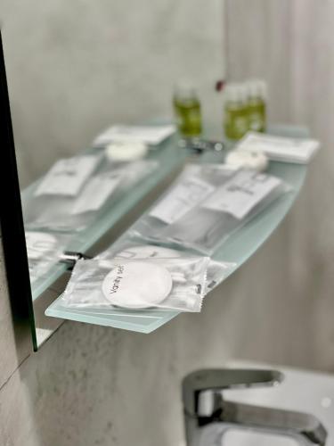 a glass counter in a bathroom with a sink at Hotel Fantazia Oradea - Self Check In & Out in Oradea