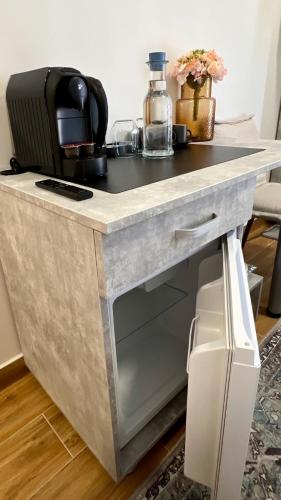 a kitchen counter with a desk with a microwave at Hotel Fantazia Oradea - Self Check In & Out in Oradea