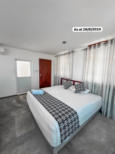 a bedroom with a large bed with curtains at White Fortress in Sri Jayewardenepura Kotte
