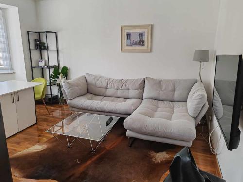 a living room with a couch and a table at Two bedroom apartment in Dollis Hill in London
