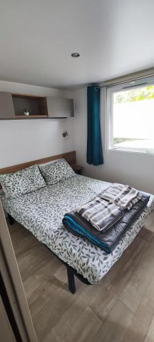 - une petite chambre avec un lit et une fenêtre dans l'établissement Mobil home camping la réserve Gastes, à Gastes