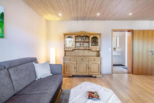 a living room with a couch and a cabinet at Triberg Blick in Triberg