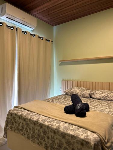 a bedroom with two beds and a bedvisor with a pillow at Villa Maia Beach - Duplex in São Miguel dos Milagres