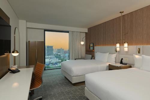 Un ou plusieurs lits dans un hébergement de l'établissement Courtyard by Marriott Santo Domingo Piantini