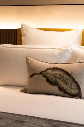 a bed with two pillows with a butterfly on it at Park Hyatt Johannesburg in Johannesburg