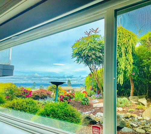 a view of a garden from a window at 1400sf Cozy Retreat with Sound View, Garden & Privacy in Federal Way