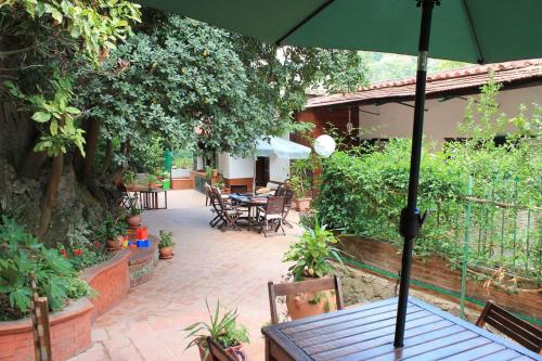 a patio with a table with an umbrella at the secret garden in Vietri sul Mare