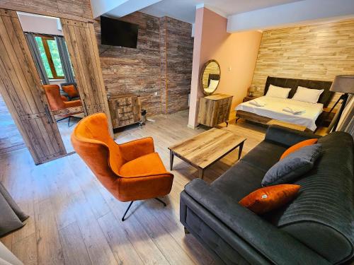 a living room with a couch and a bed at Alen Mak Forest Hotel in Lipnik