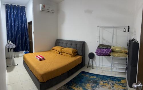 a bedroom with a bed with yellow sheets and yellow pillows at LaRinDa Teluk Kemang Private Pool - Islamic in Port Dickson