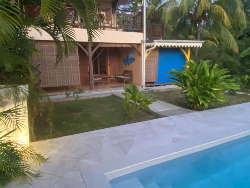 a view of the house from the pool at Colibri Villa Sainte Luce in Sainte-Luce