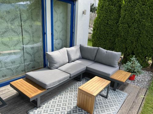 a couch and two benches on a patio at Haus Sonnenweg in Mariapfarr