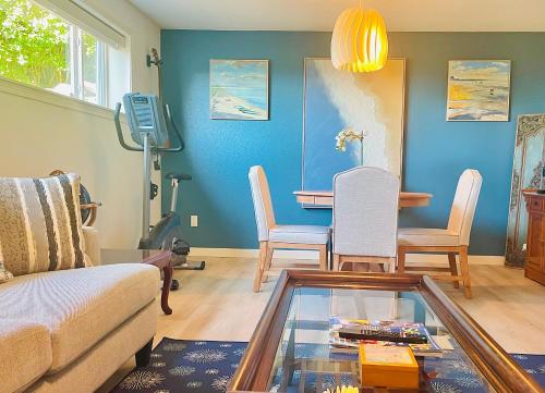 a living room with a couch and a table at 1400sf Cozy Retreat with Sound View, Garden & Privacy in Federal Way